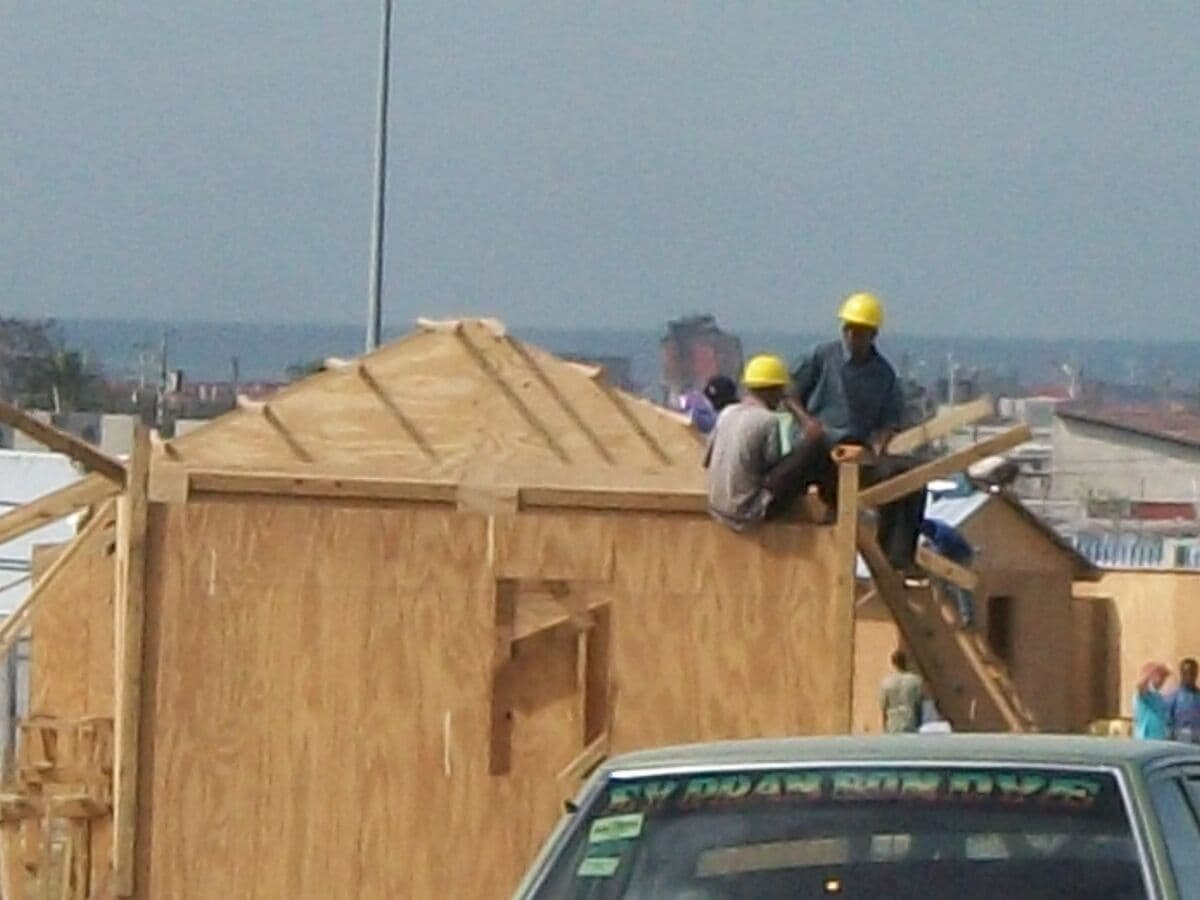Deaf workers building a rooftop in Haiti